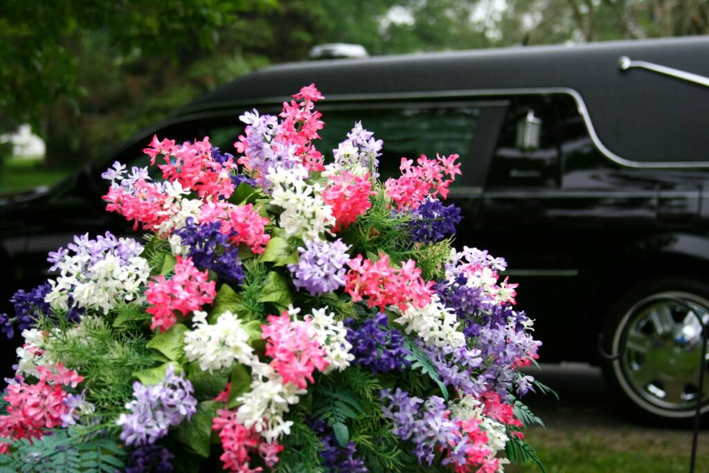 Vibrant flowers and Funeral Hearse