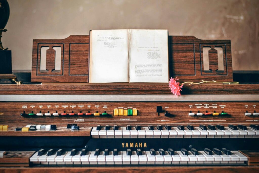 A piano with songs lyrics and flower