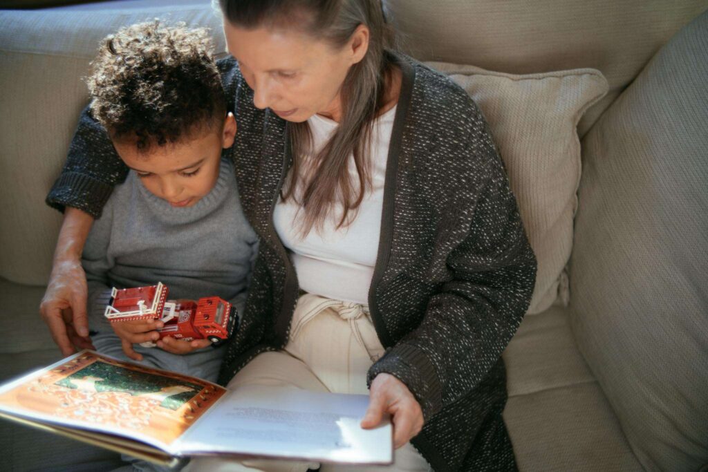 A lady reading book to a kid
