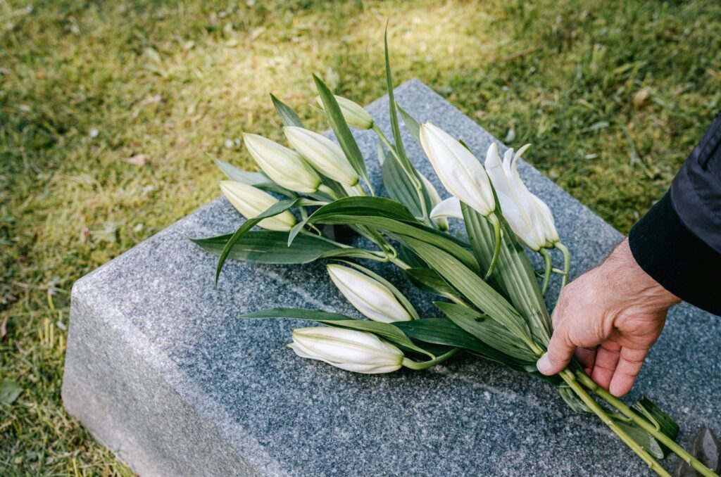 Laying Flowers over a Gravestone