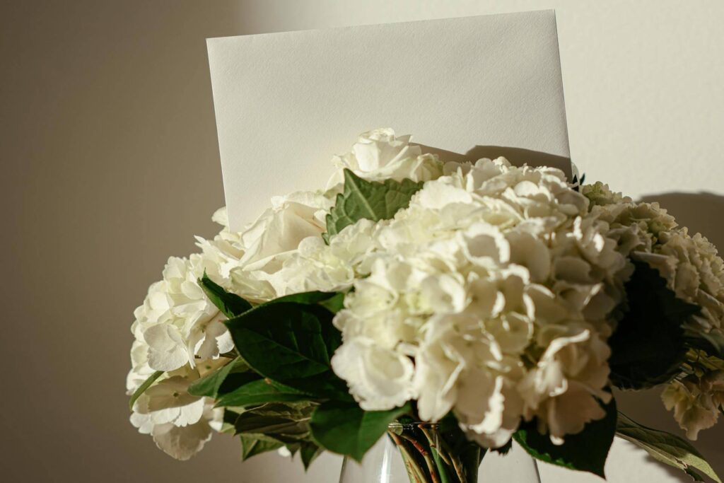 Black Card on Top of White Flowers